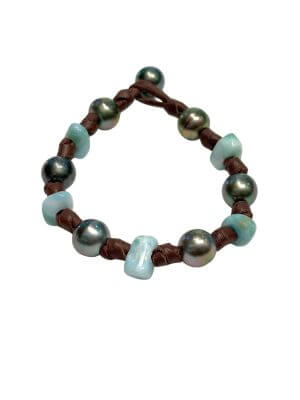 Bracelet featuring seven Tahitian pearls and one Larimar pearl mounted on hand-rolled leather.