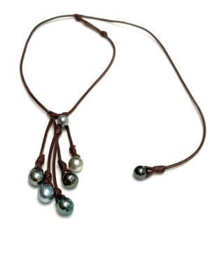 1. Cluster necklace of seven semi-baroque Tahitian pearls mounted on hand-rolled kangaroo leather, shown in classic style.