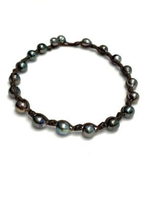 Convertible necklace or double-wrap bracelet with 17 Tahitian pearls mounted on hand-rolled kangaroo leather.