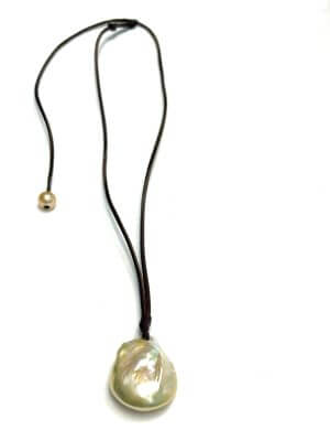 Adjustable necklace with large fireball freshwater pearl on hand-rolled kangaroo leather, featuring a sliding clasp with a smaller pearl.