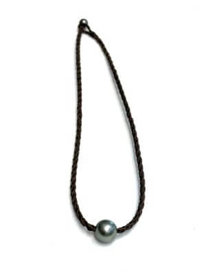 Choker necklace with semi-round Tahitian pearl on hand-braided kangaroo leather, handcrafted in St. Barthélemy.