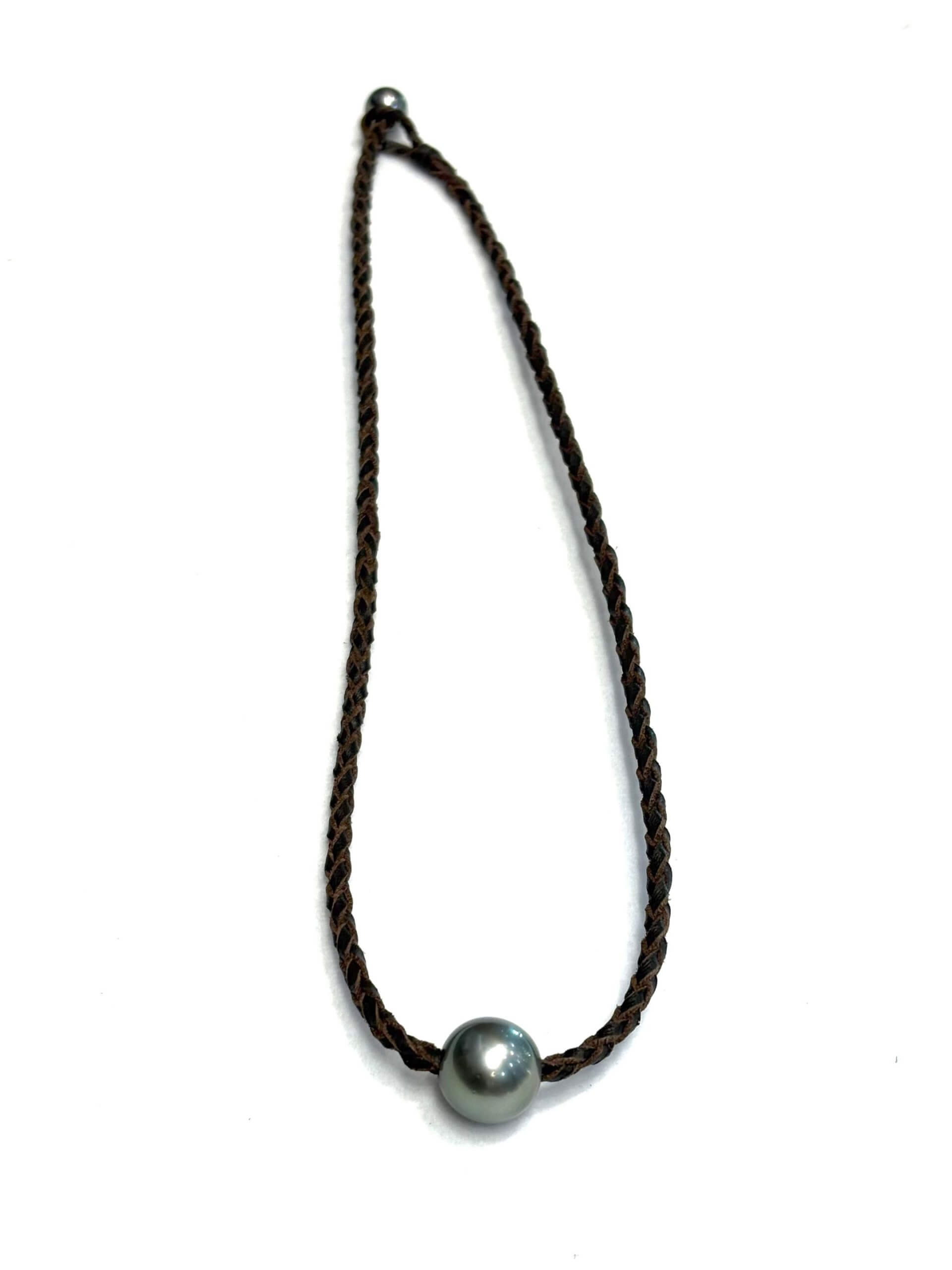 Choker necklace with semi-round Tahitian pearl on hand-braided kangaroo leather, handcrafted in St. Barthélemy.