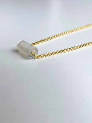 Delicate 18K gold-plated sterling silver necklace, 40 cm length, adjustable to 38 cm and 36 cm, with a 1.2 cm clear quartz charm; handcrafted from recycled materials, symbolizing clarity, renewal, and transformation.