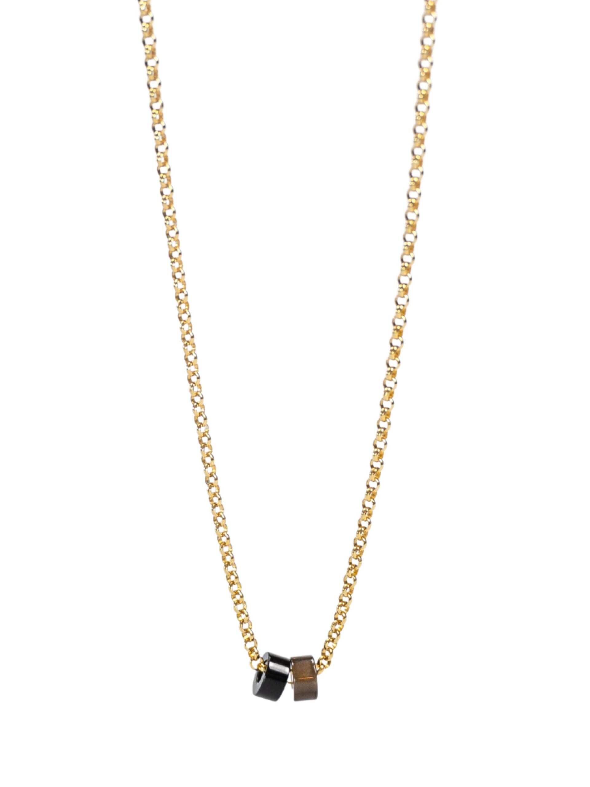 „Timeless 18K gold-plated sterling silver necklace, 48 cm length, adjustable to 46 cm and 44 cm, with two crystal donut pendants in onyx and smoky quartz; handcrafted from recycled materials, symbolizing grounding, clarity, and transformation.“