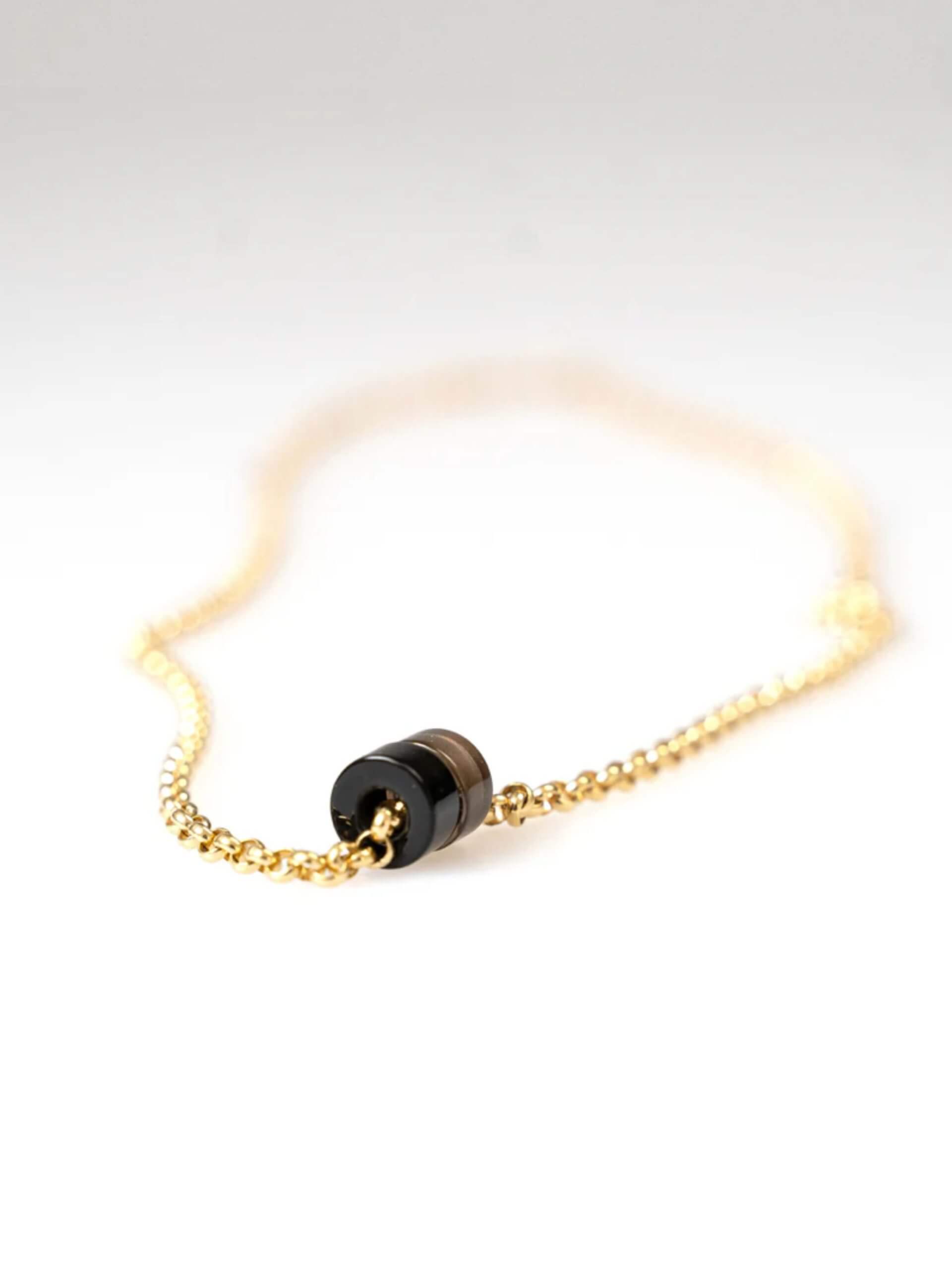 „Timeless 18K gold-plated sterling silver necklace, 48 cm length, adjustable to 46 cm and 44 cm, with two crystal donut pendants in onyx and smoky quartz; handcrafted from recycled materials, symbolizing grounding, clarity, and transformation.“