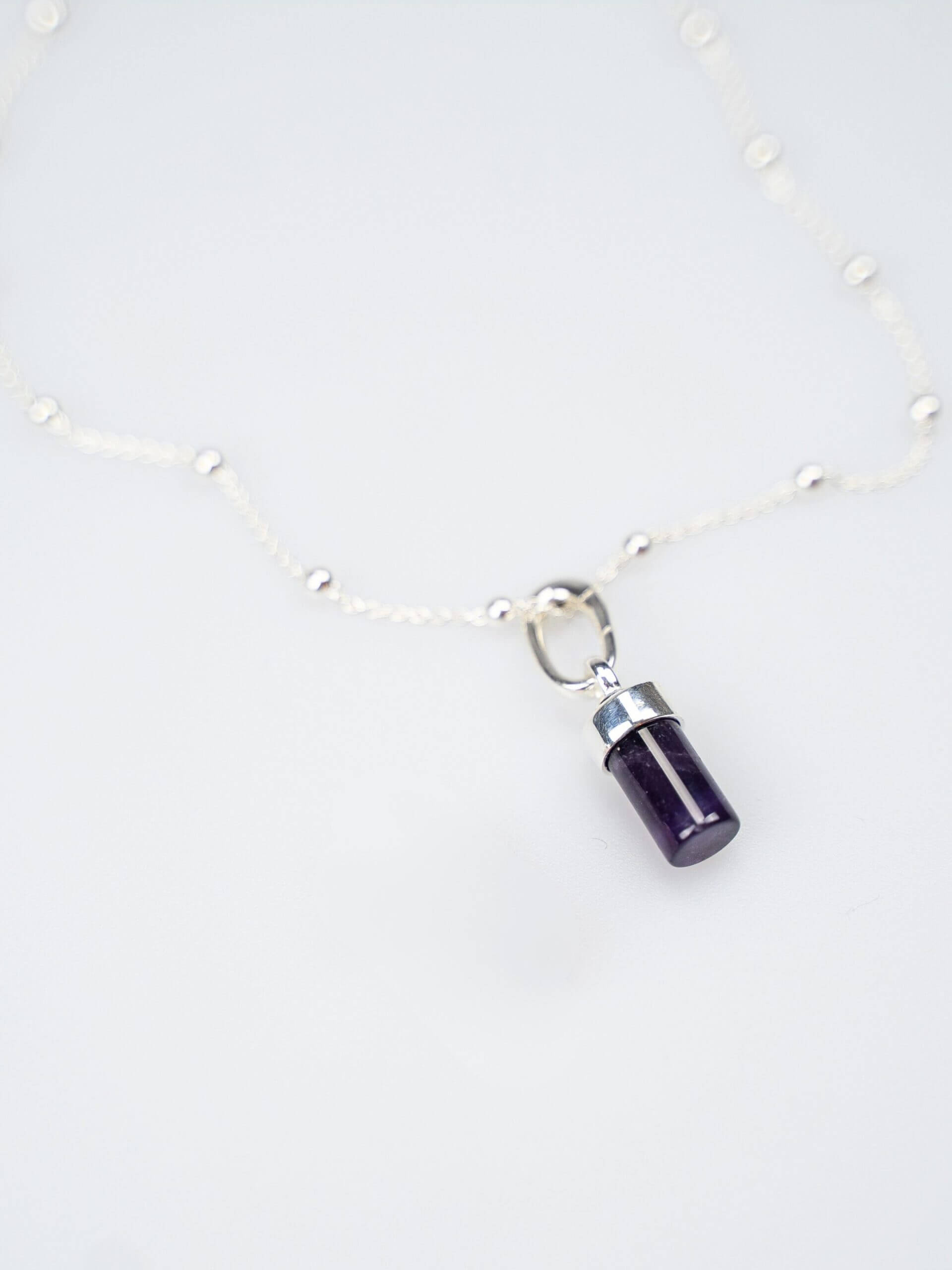 „Delicate silver ball chain necklace, 42 cm length with two additional adjustment options at 40 cm and 38 cm, featuring a radiant amethyst charm; handcrafted from recycled 925 sterling silver, symbolizing intuition, clarity, and spiritual growth.“