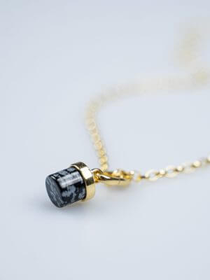 „Delicate gold ball chain necklace, 42 cm length with two additional adjustment options at 40 cm and 38 cm, featuring a snowflake obsidian charm; handcrafted from recycled 925 sterling silver with recycled 18K gold plating, symbolizing grounding, clarity, and transformation.“