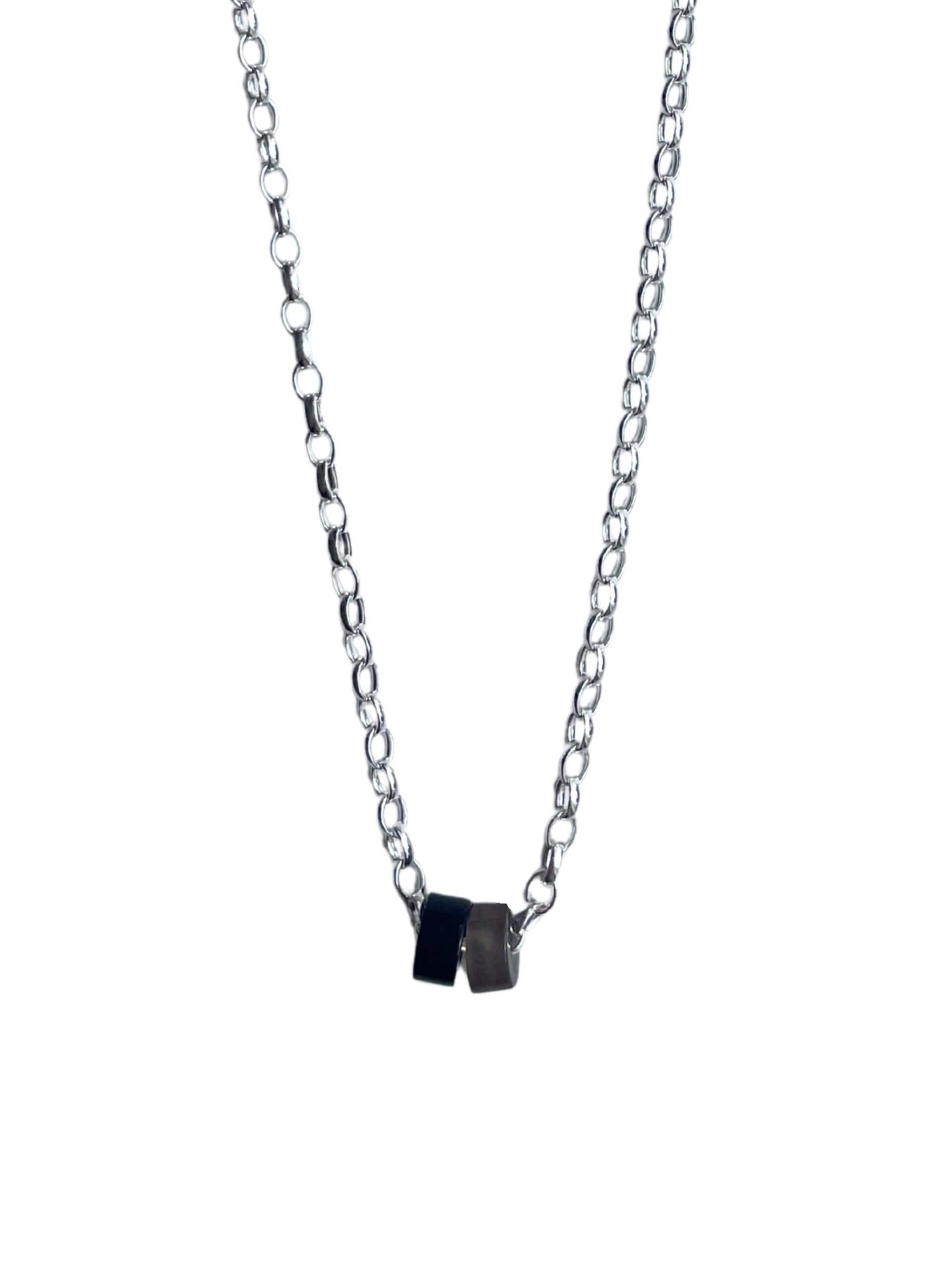 „Timeless sterling silver necklace, 48 cm length, adjustable to 46 cm and 44 cm, with two crystal donut pendants in onyx and smoky quartz; handcrafted from recycled materials, symbolizing grounding, clarity, and transformation.“