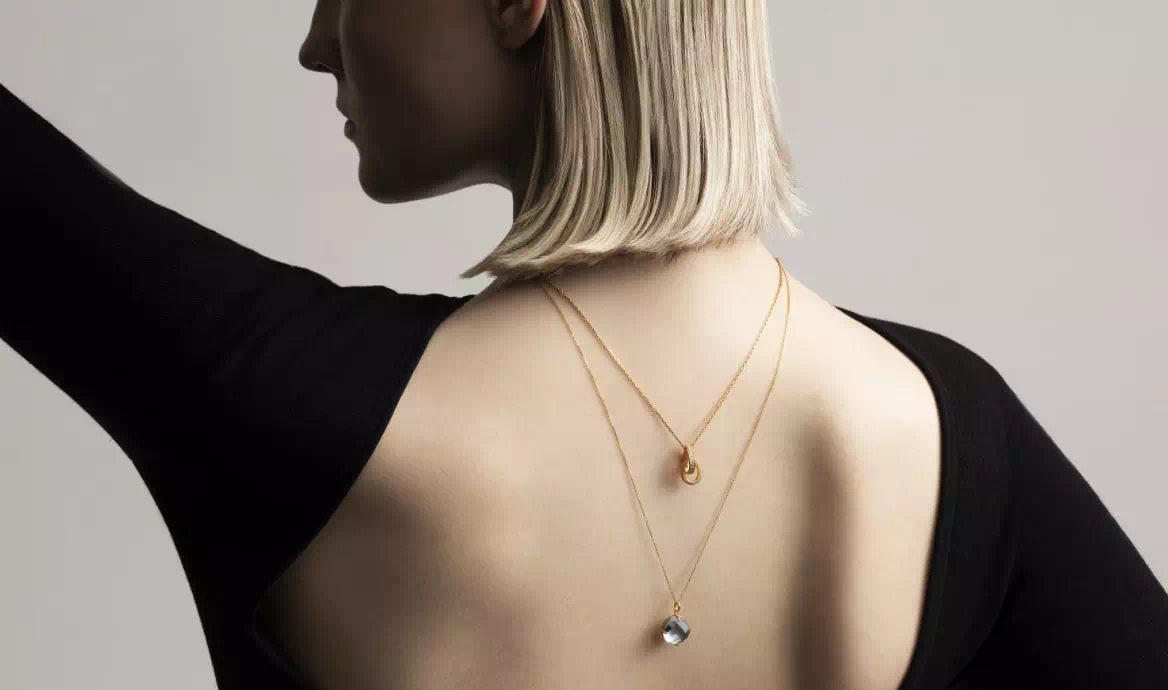 Model wearing KAKERA gold jewelry 10k necklaces, exclusively available at Flying Solo Paris.